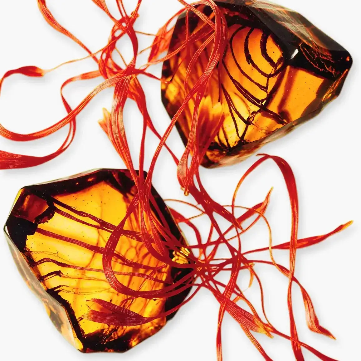 Godolphin fragrance featuring rich amber notes and vibrant saffron strands, showcasing elegance and warmth.